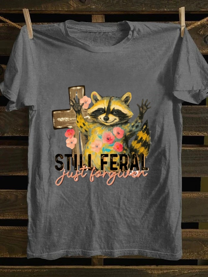 One T - shirt, one raccoon, and a fascinating story of ‘still wild, thankfully forgiven’. Just wear it!
